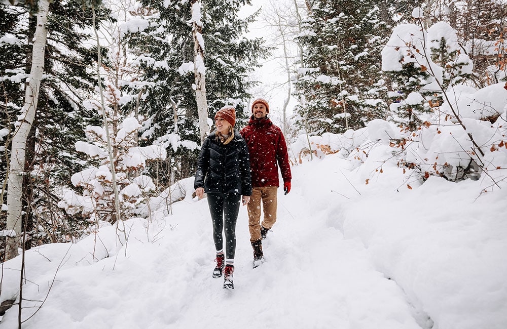 Couple exploring snowy mountain